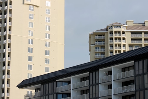 Modern residential buildings with balconies under a clear sky.