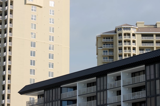 Modern residential buildings with clean architecture under a clear sky.