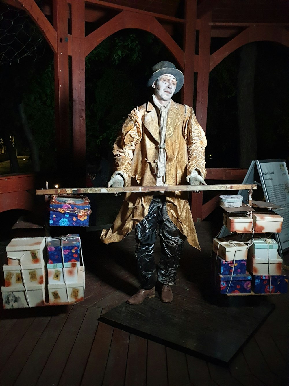 man holding wooden stick in between box lot