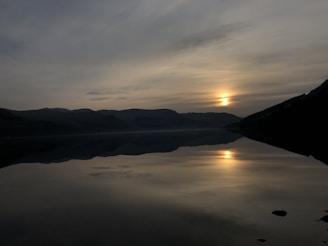 A serene landscape featuring a soft sunrise over a calm lake, symbolizing inner light and tranquility.