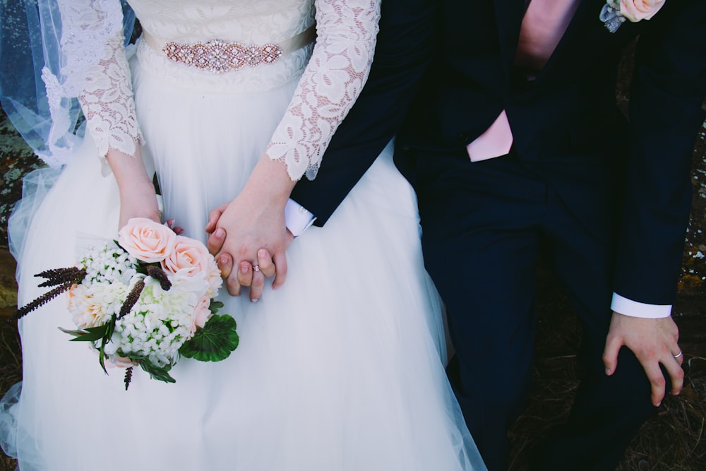 bride and gold holding hands while sitting