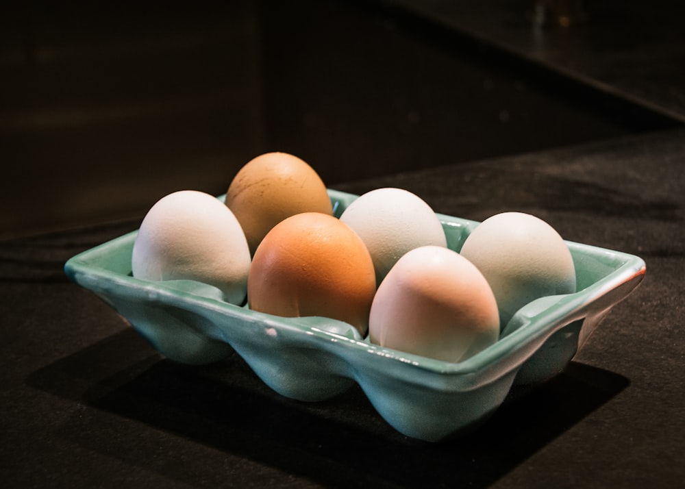 six white and brown eggs