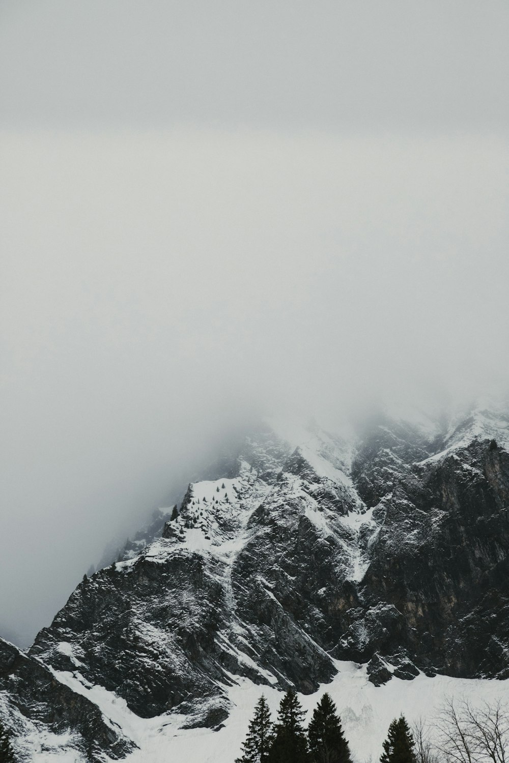 fog covered snow capped mountain range