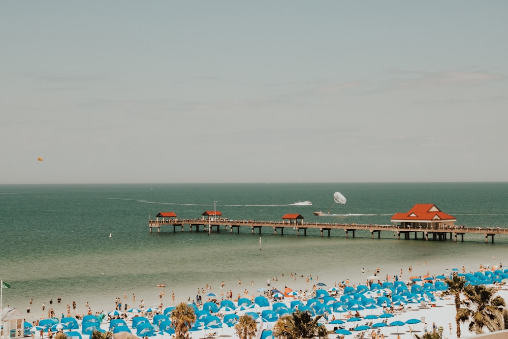 blue and white tents in crowded beach