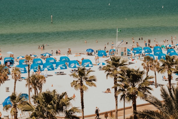 blue and white tents in beach with people