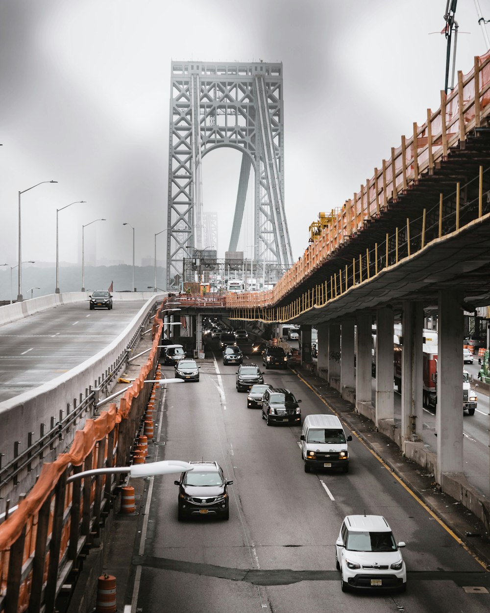 vehicle traveling on road during passing by bridge during daytime