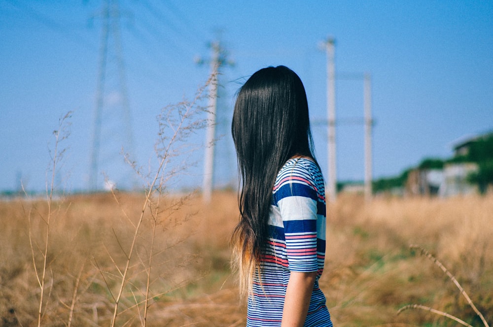 selective focus photography of woman standing near outdoor during daytime