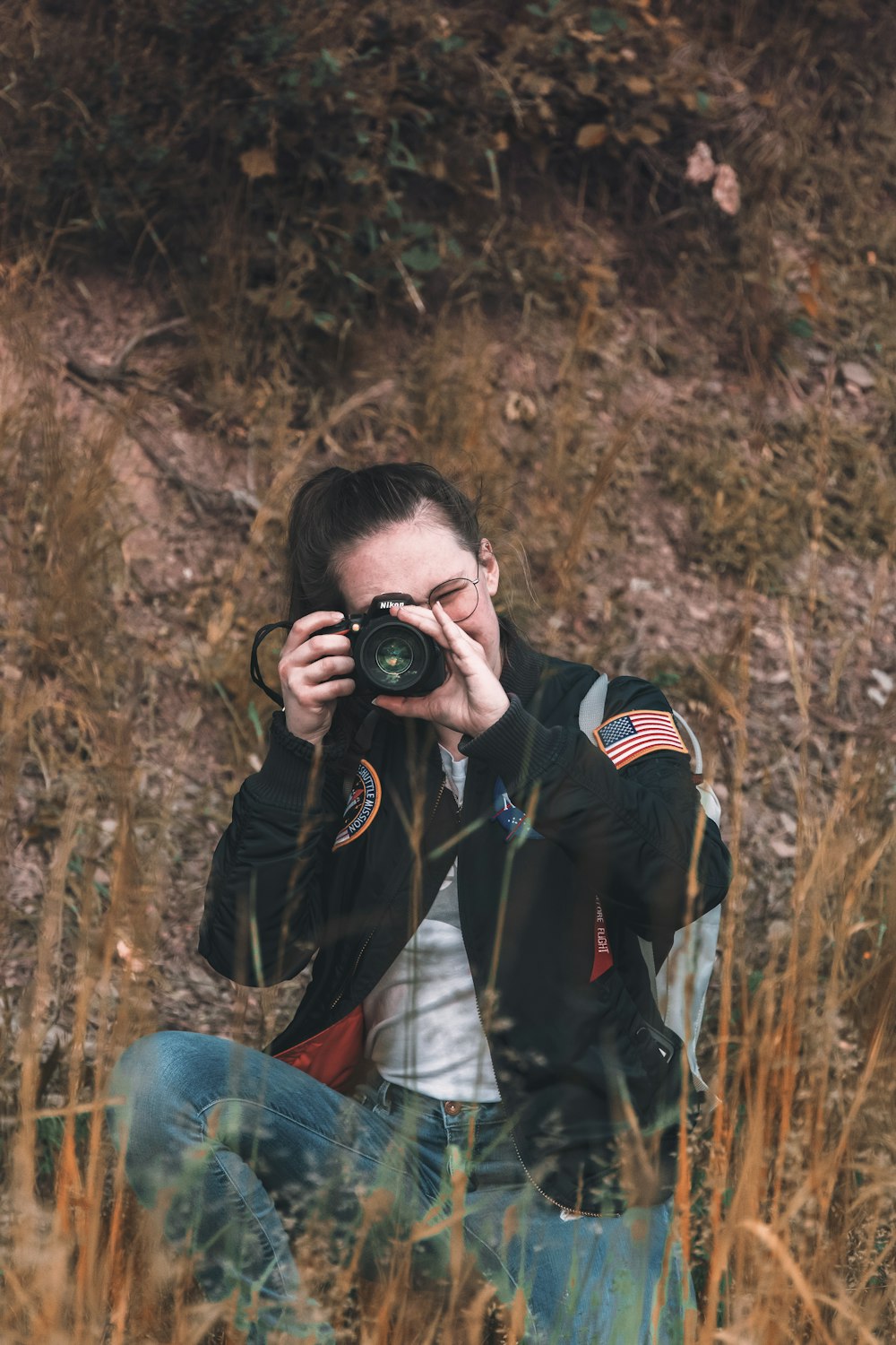 woman holding camera outdoor during daytime