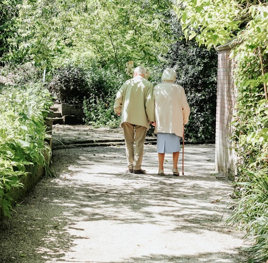 man and woman walking on road during daytime