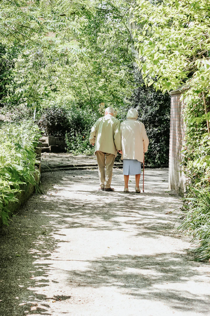Man and woman walking together down a road in daylight