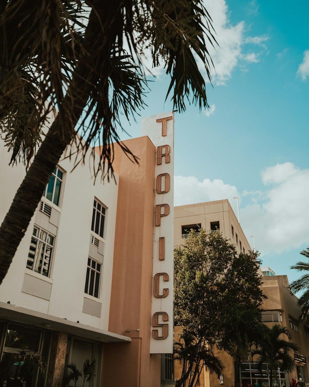 low angle photo of tropics signage