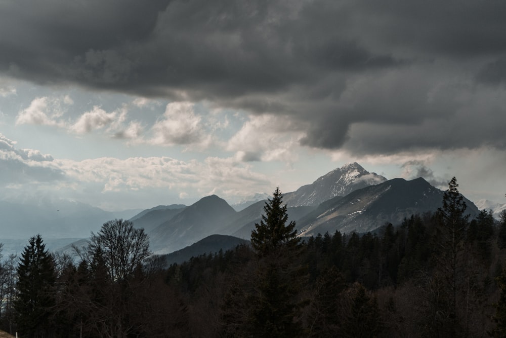 mountain range under cloudy sky during daytime