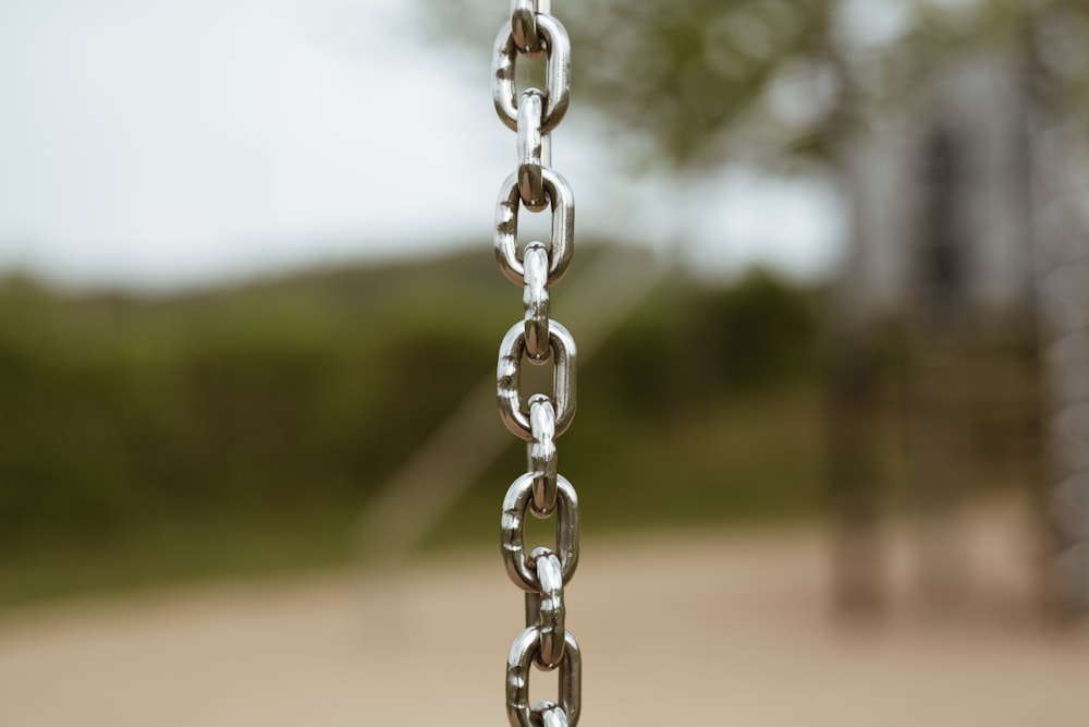 selective focus photography of silver-colored chain during daytime