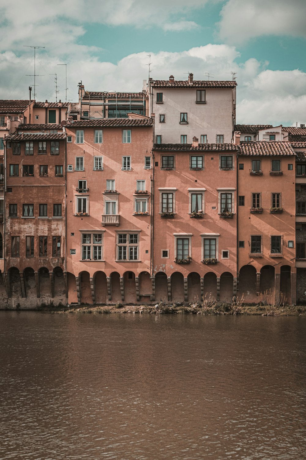 brown concrete canal house during daytime