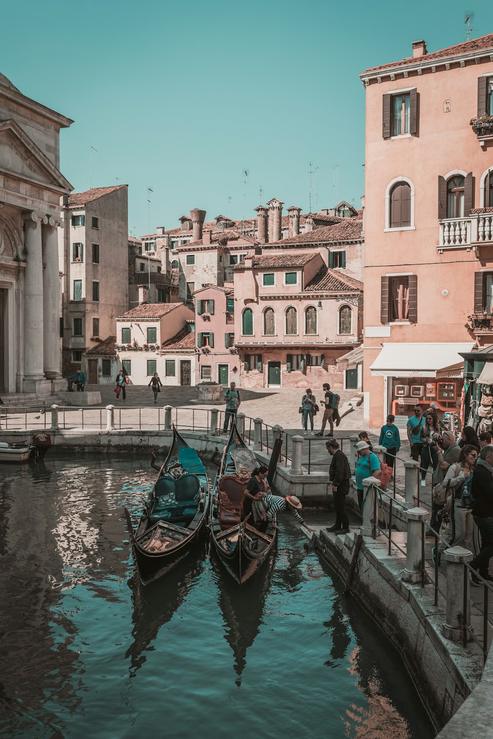 people standing beside boat and building during daytime