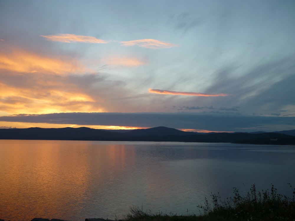 body of water near mountains