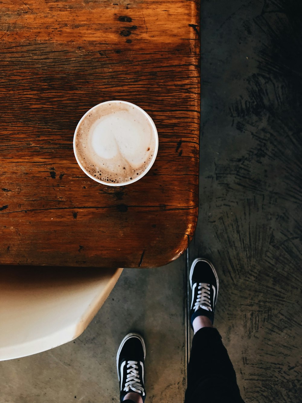 filled cup of cup on brown wooden table