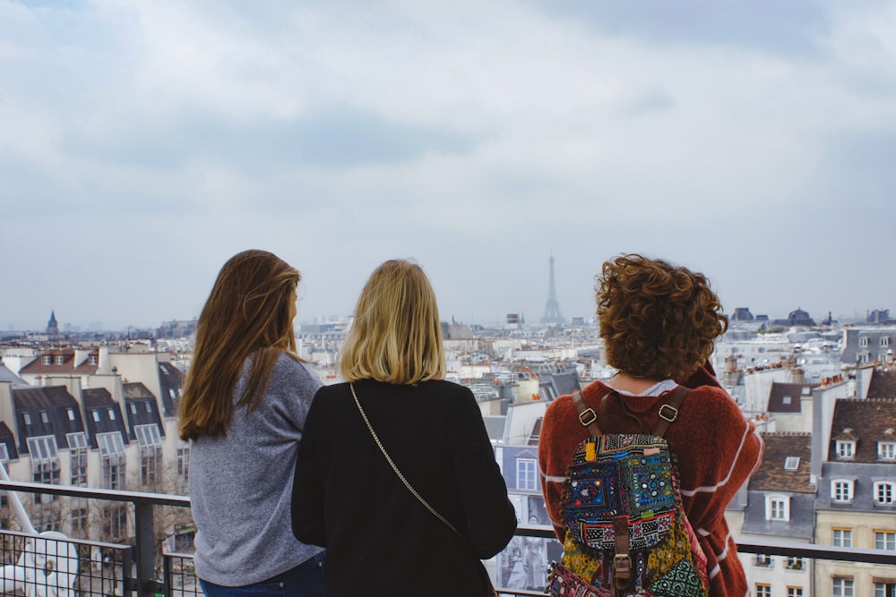 three women facing cityscape