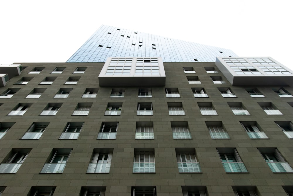 low angle photography of brown and glass high-rise building