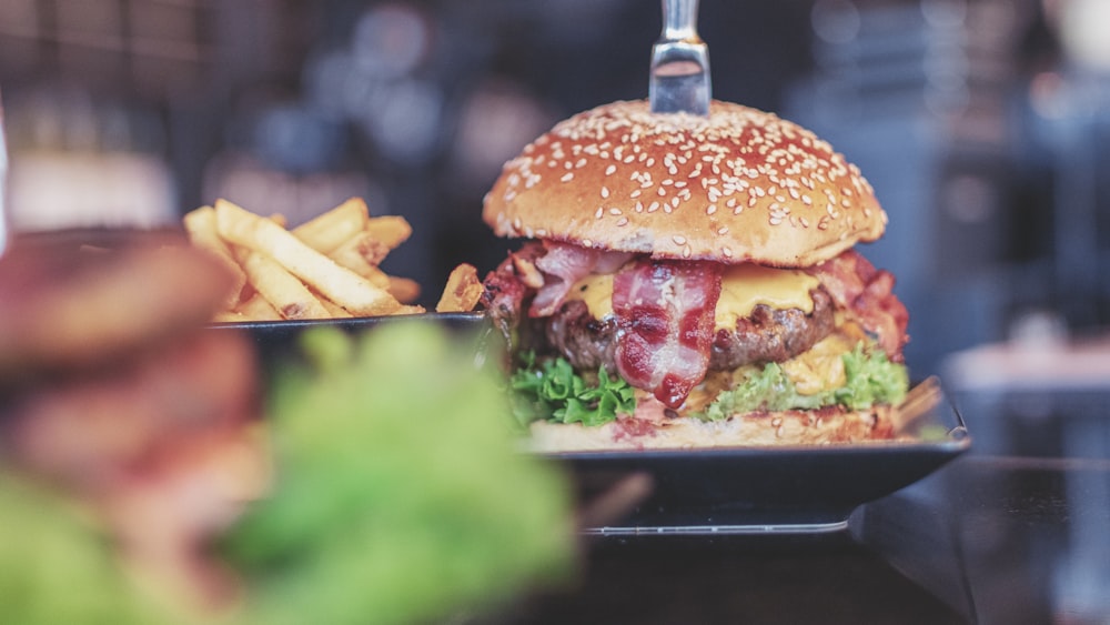 selective focus photo of burger with bacon