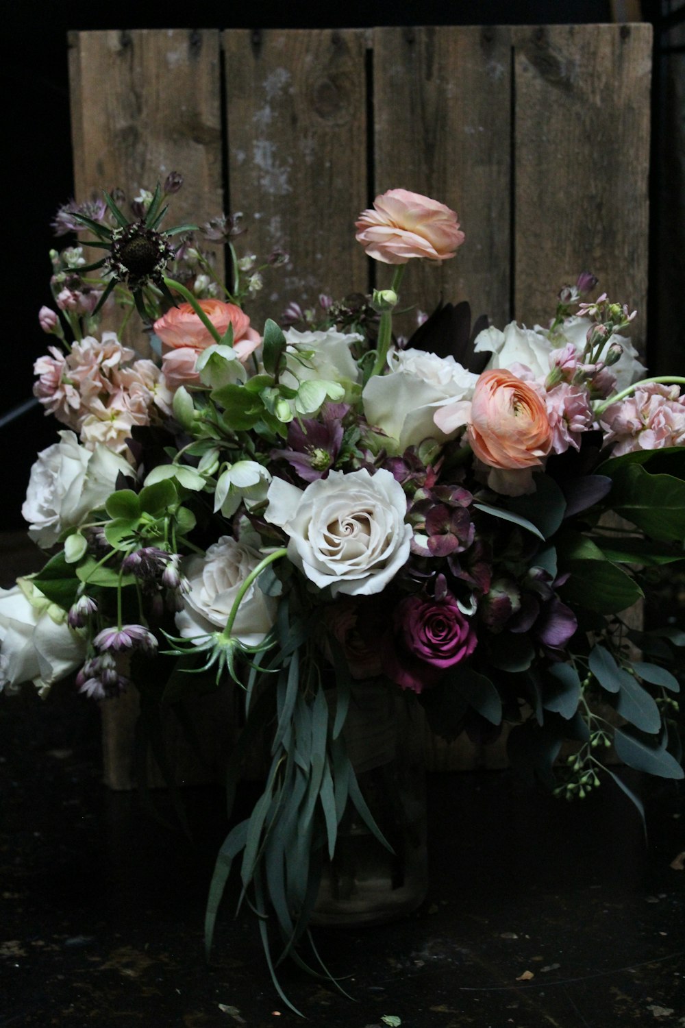 assorted-color flower arrangement in wooden pallet