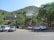 A diverse fleet of rental cars parked neatly in an open lot under clear skies.