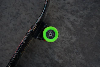 Dynamic shot of a skateboard wheel glowing with electric blue accents while spinning.