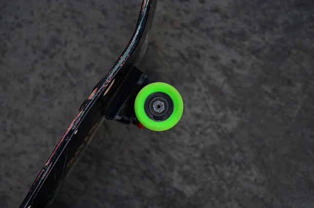 Close-up of a skateboard wheel spinning fast on an urban street pavement