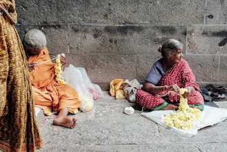 woman seated on concrete pavement
