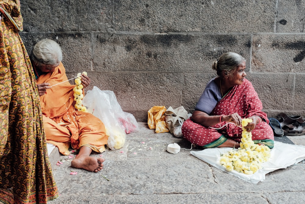 woman seated on concrete pavement