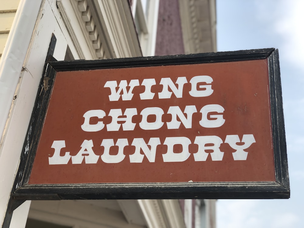brown and black wing chong laundry signage