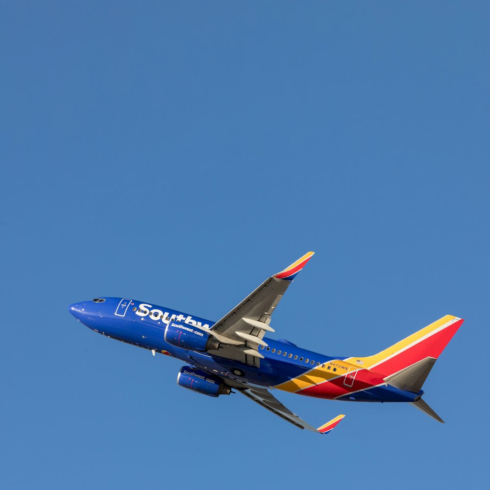 blue and red airplane on midair