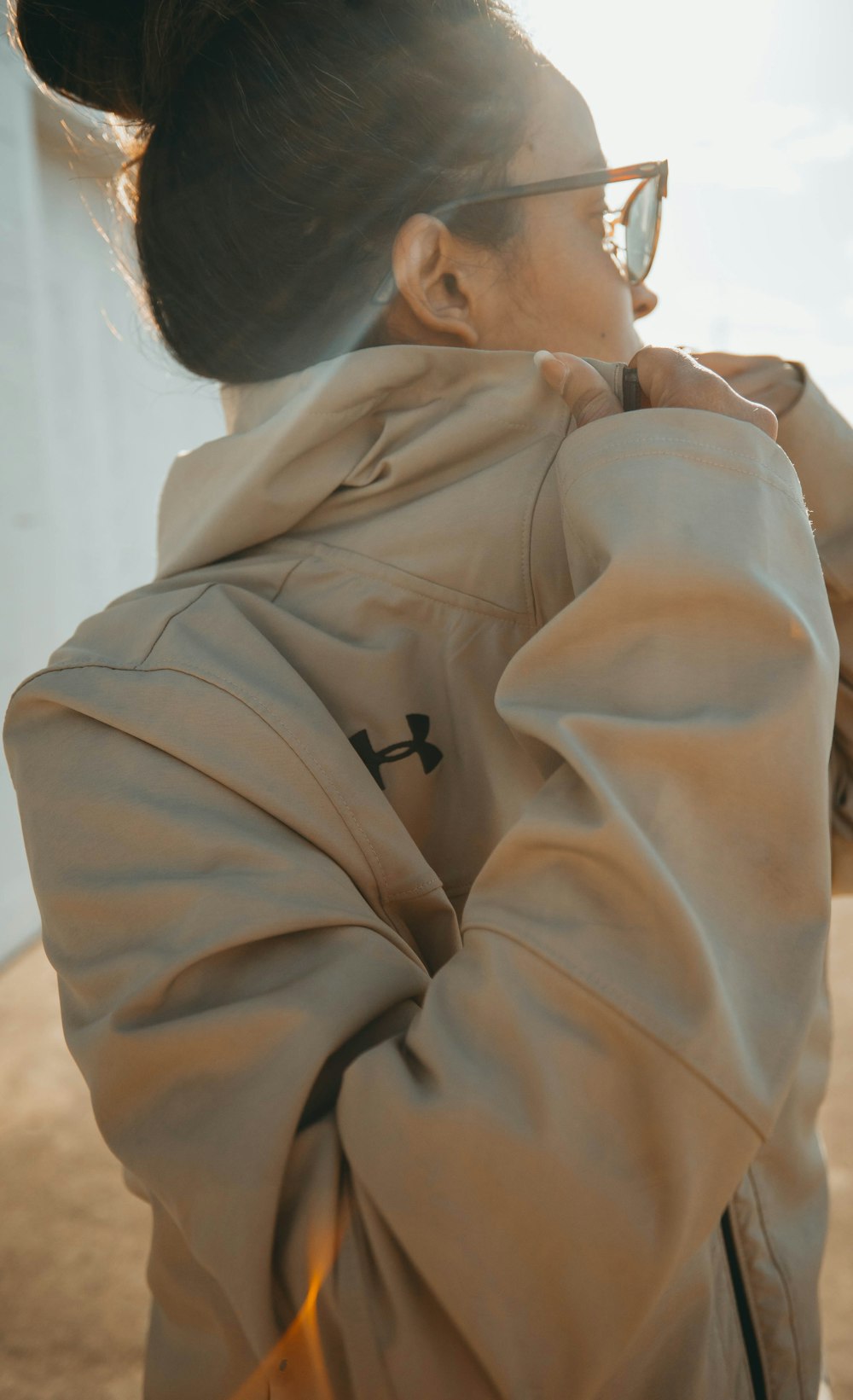 woman in beige Under Armour jacket during daytime