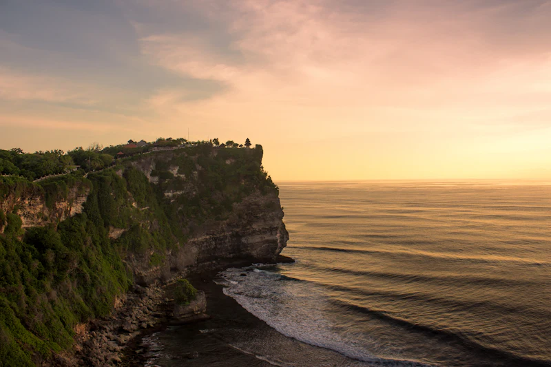 Sea below a cliff in golden light