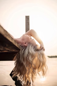 woman lying on river dock