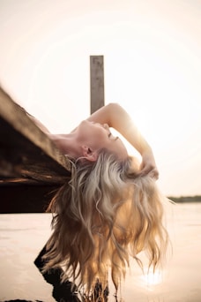 woman lying on river dock