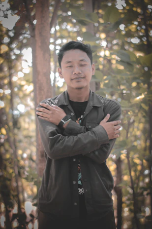 A serene person meditating quietly in a sunlit forest clearing, embodying peaceful awareness.