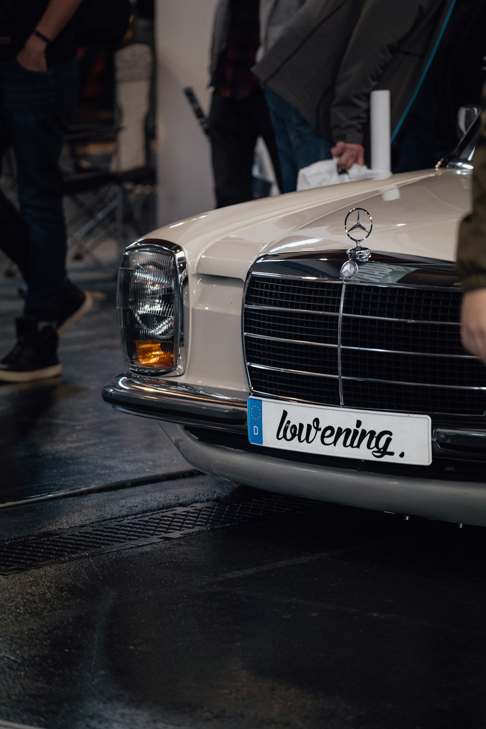 people gathering beside Mercedes-Benz vehicle