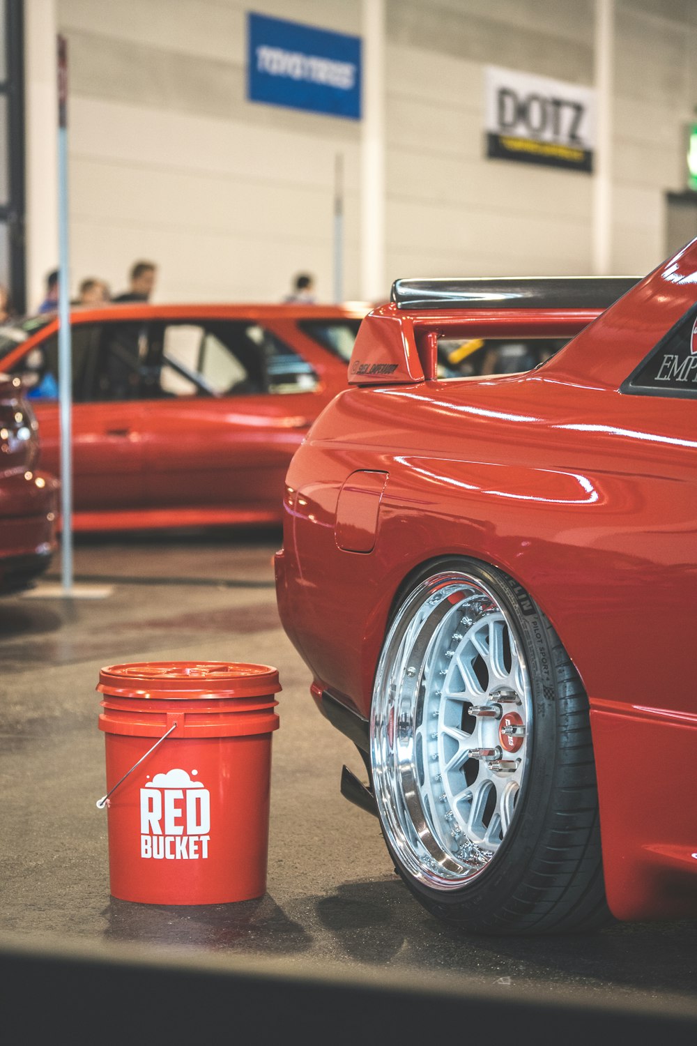 red bucket beside red vehicle