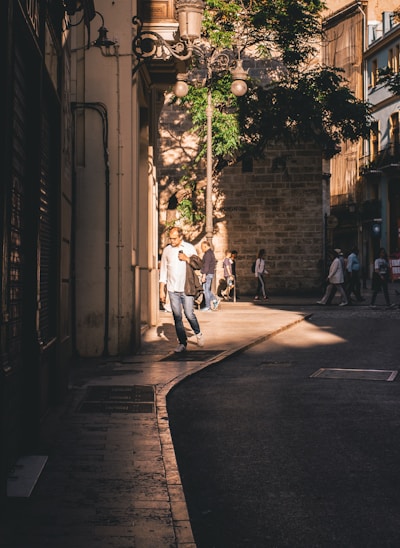 A charming village street bathed in warm afternoon light, showcasing local architecture.
