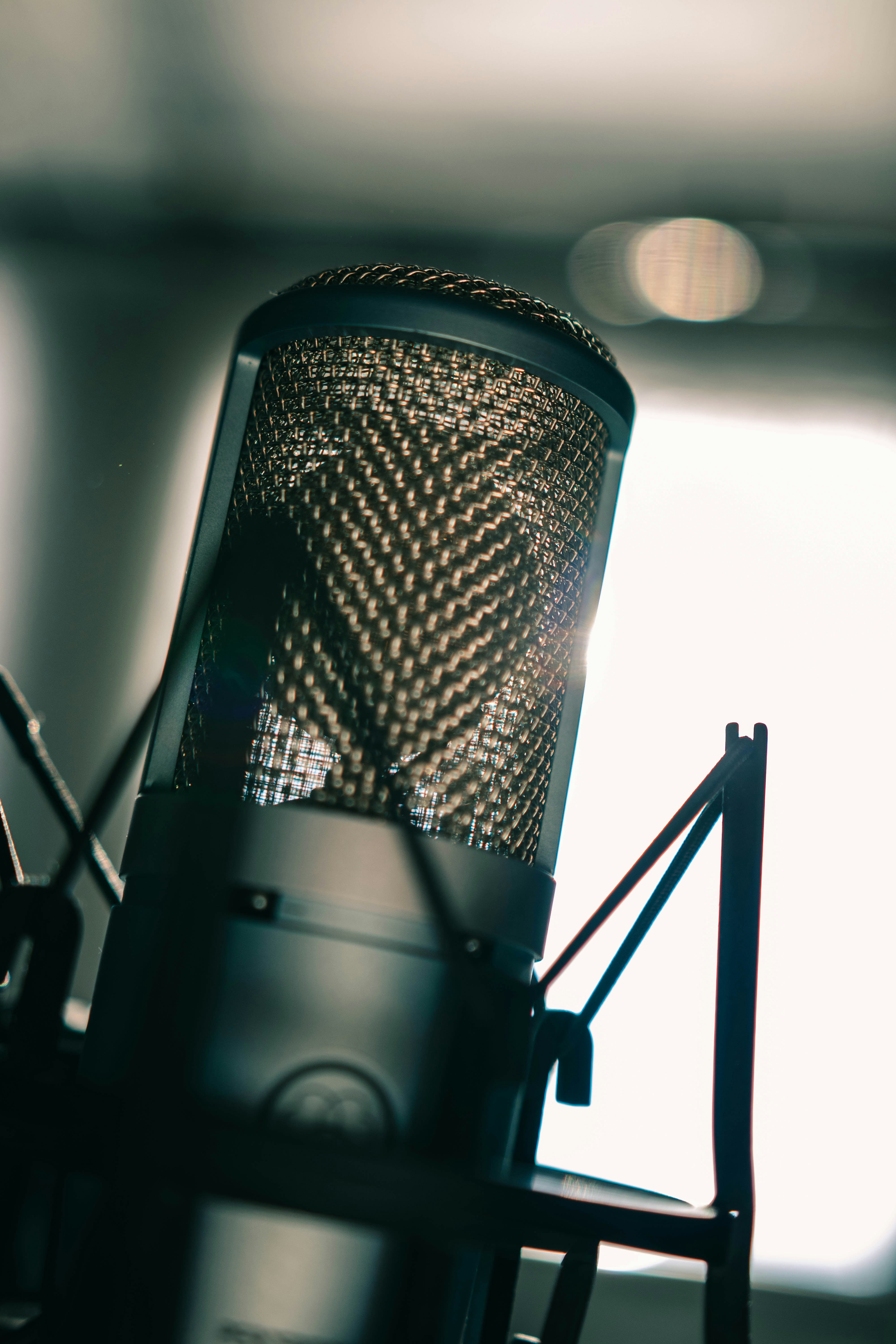 Close-up of a professional microphone in a home practice environment with warm ambient lighting
