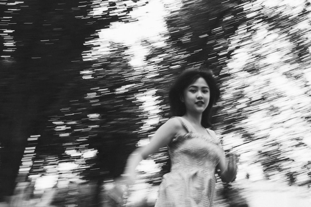 grayscale photography of woman surrounded by trees