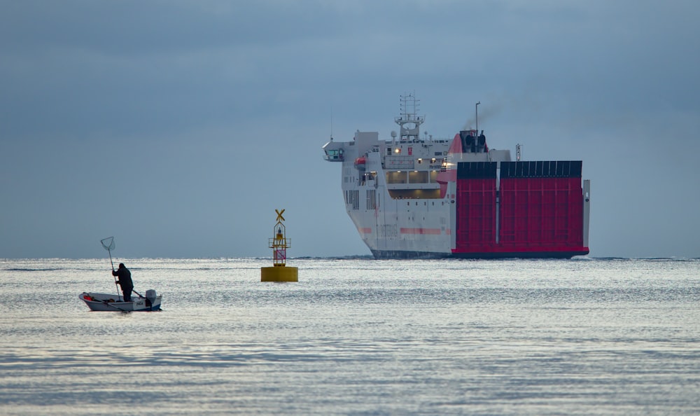 silhouette of person riding white boat during daytime