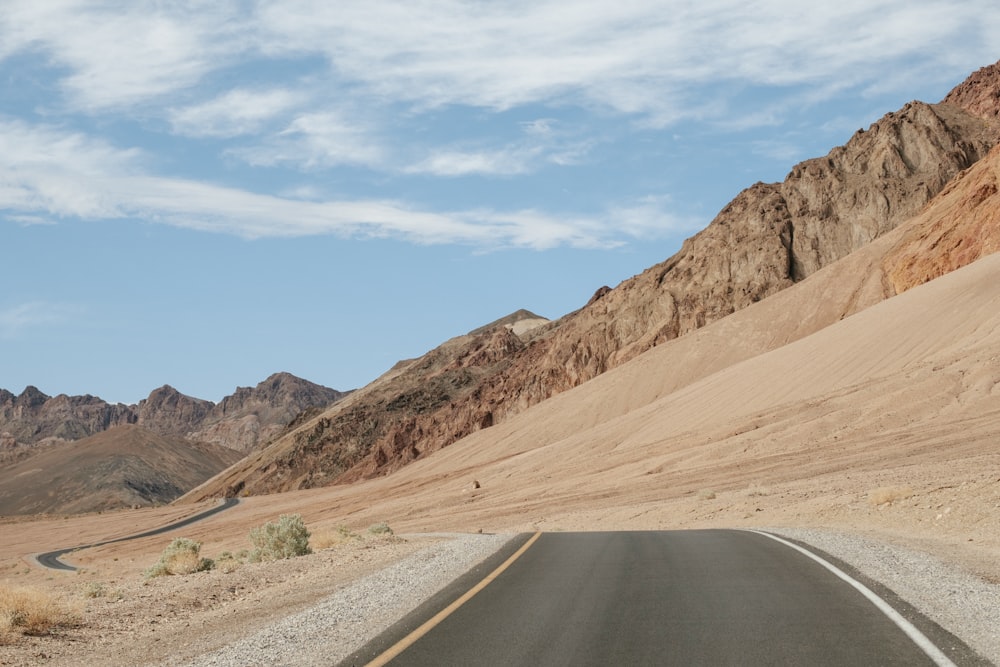 empty road beside rock mountain