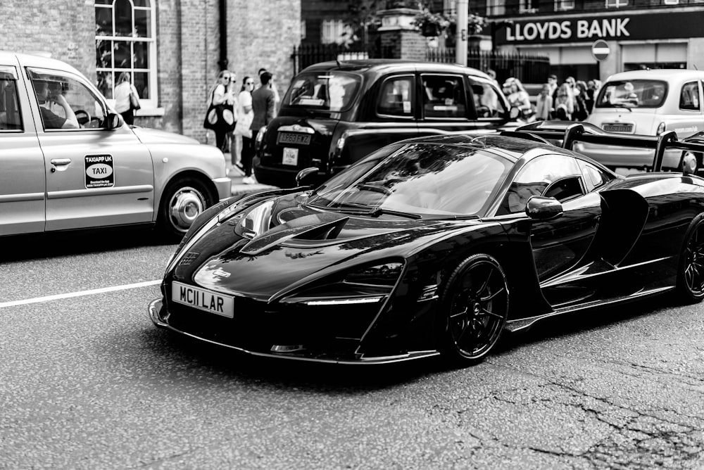 grayscale photography of coupe on road