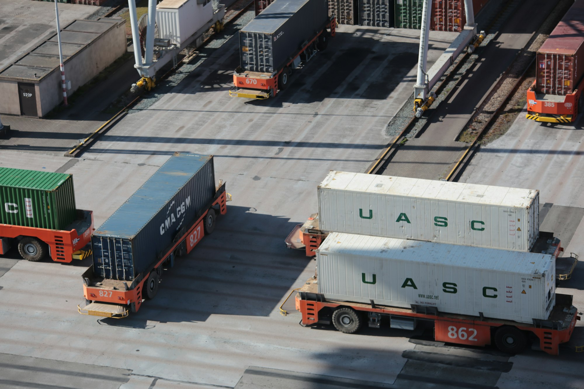 Shipping containers being moved in a shipyard.