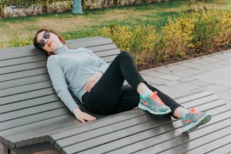 unknown celebrity lying on brown lounge chair outdoors