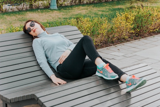 unknown celebrity lying on brown lounge chair outdoors