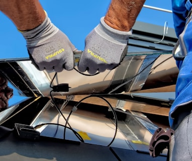 two men carrying a metal sheet