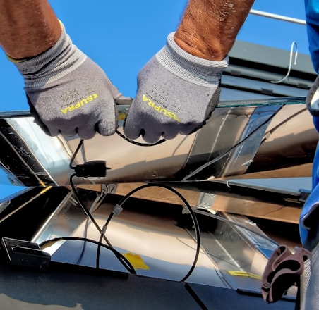 two men carrying a metal sheet